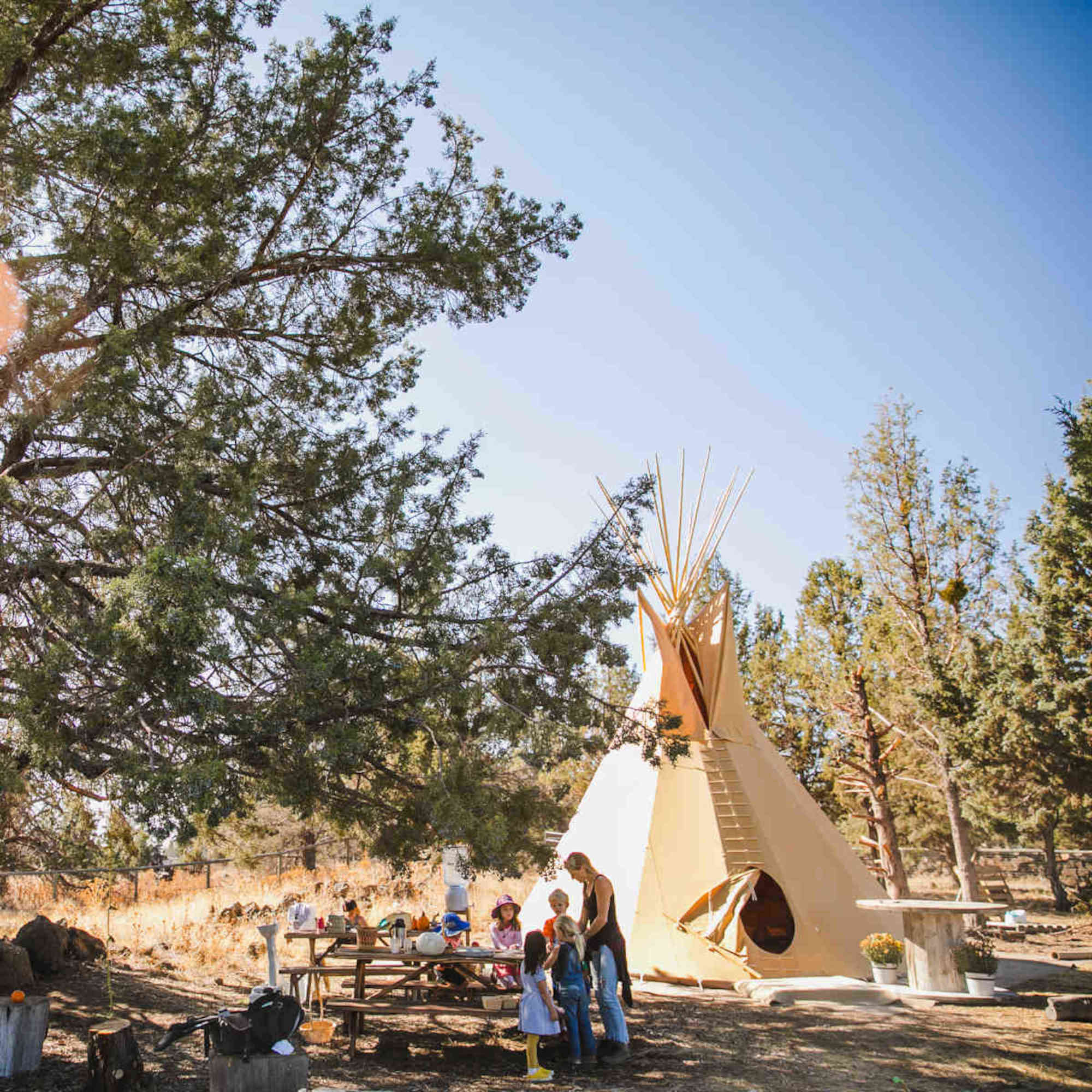 Tess with kids and tipi at Wildheart's Bend outdoor kindergarten
